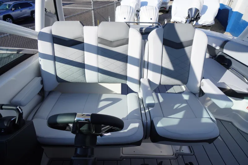 Slide: The Image of 2026 Chaparral 280 OSX boat interior with modern seating and steering wheel. - 31