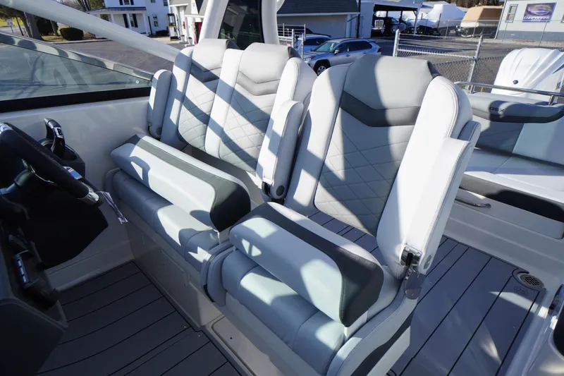 Slide: The Image of 2026 Chaparral 280 OSX boat interior with modern, cushioned seating and sleek design. - 32