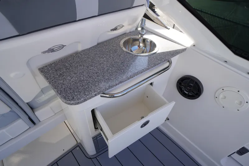 Slide: The Image of 2026 Chaparral 280 OSX boat interior with sink and storage drawer. - 36