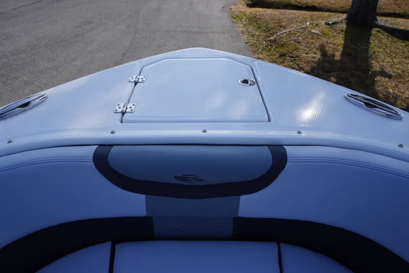 Slide: The Image of Bow view of 2026 Chaparral 280 OSX boat with sleek design and storage hatch. - 4