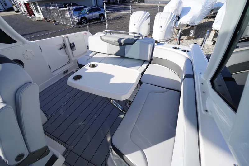 Slide: The Image of 2026 Chaparral 280 OSX boat interior with seating and table, showcasing modern design. - 43