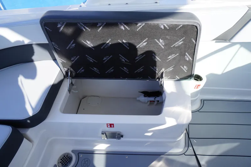 Slide: The Image of Open storage compartment on 2026 Chaparral 280 OSX boat, featuring branded interior. - 47