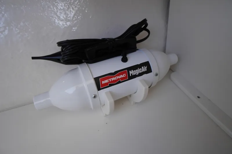 Slide: The Image of Metrovac MagicAir inflator in Chaparral 280 OSX, 2026 model boat storage. - 48