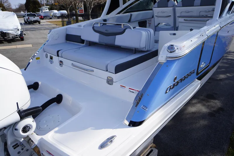 Slide: The Image of 2026 Chaparral 280 OSX boat with blue and white exterior, featuring spacious seating. - 54