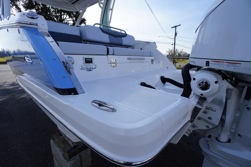 Slide: The Image of 2026 Chaparral 280 OSX boat rear view with seating and engine details. - 60