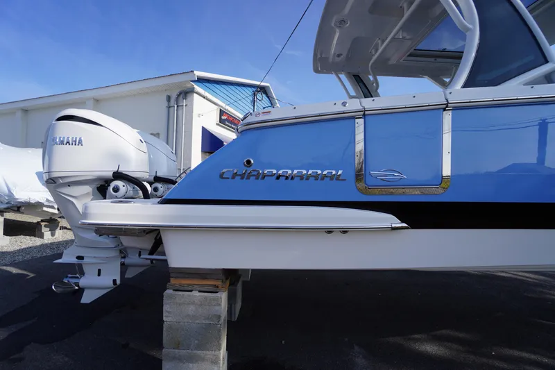 Slide: The Image of 2026 Chaparral 280 OSX boat with Yamaha engine, displayed outdoors. - 61