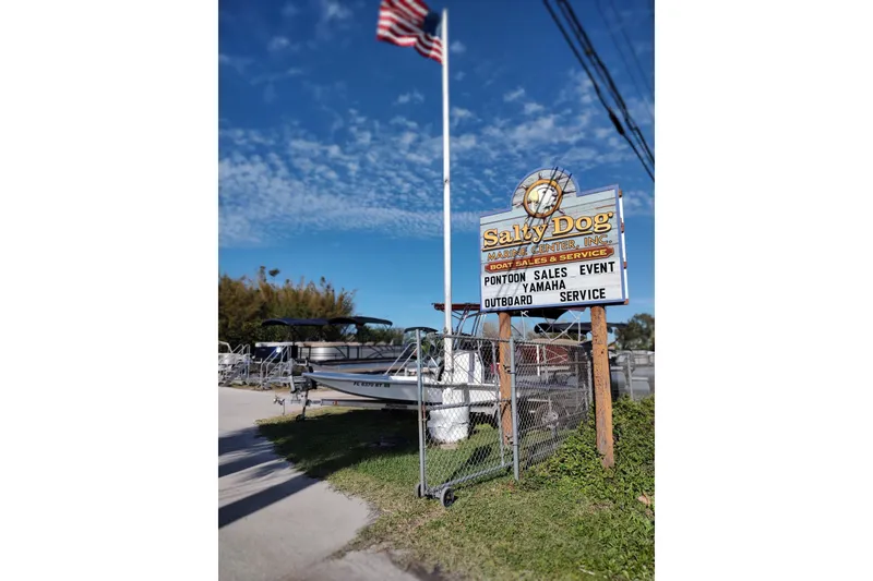 Slide: The Image of Salty Dog Marina Center with Sylvan Mirage 820 PARTY FISH boat, 2026 model, under clear sky. - 13