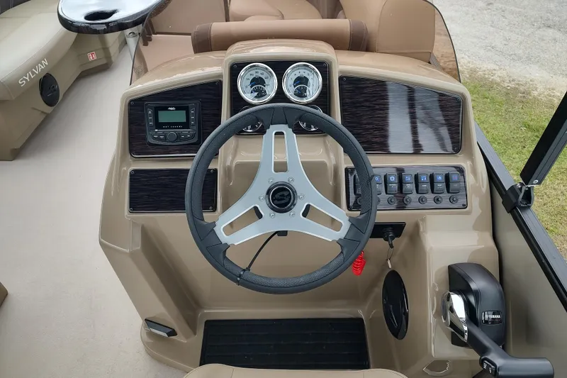 Slide: The Image of 2026 Sylvan Mirage 820 PARTY FISH boat dashboard with steering wheel and controls. - 18