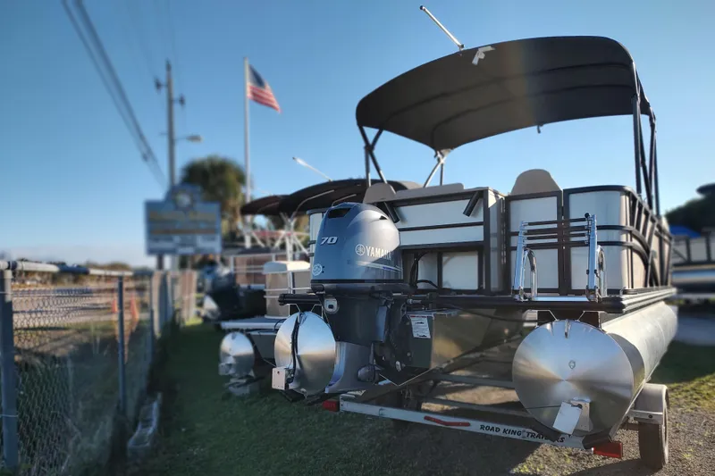 Slide: The Image of 2026 Sylvan Mirage 820 PARTY FISH pontoon boat with Yamaha motor, parked outdoors. - 3