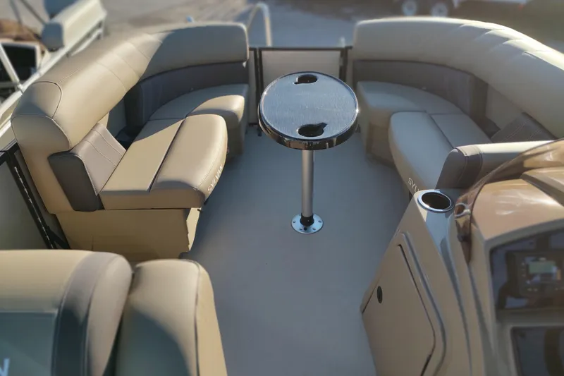Slide: The Image of 2026 Sylvan Mirage 820 PARTY FISH boat interior with beige seating and central table. - 4