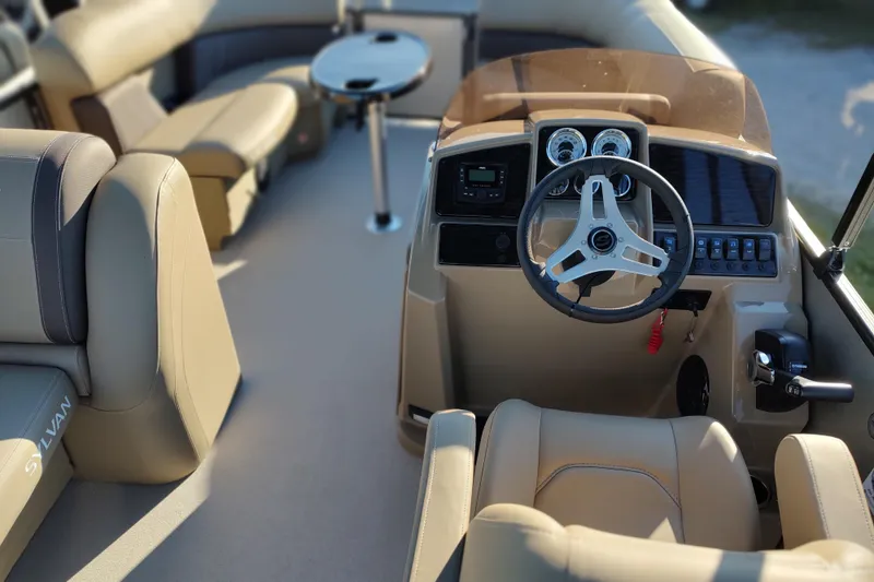 Slide: The Image of 2026 Sylvan Mirage 820 PARTY FISH boat interior with steering wheel and seating. - 6