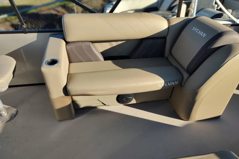 Slide: The Image of Luxurious seating on 2026 Sylvan Mirage 820 PARTY FISH boat, featuring beige upholstery and cup holder. - 8