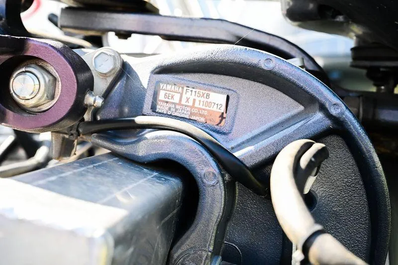 Slide: The Image of Close-up of a Yamaha F115XB engine component on a 2023 Aloha Pontoon boat. - 10