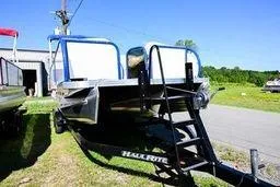 Slide: The Image of 2023 Aloha Pontoon boat on trailer, sunny outdoor setting. - 5