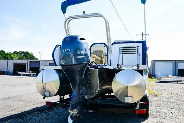 Slide: The Image of 2023 Aloha Pontoon boat with Yamaha 115 engine, parked outdoors. - 6