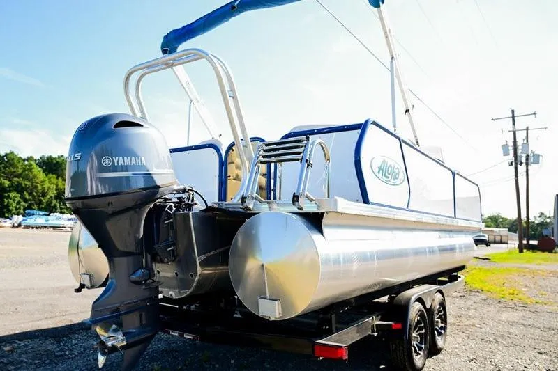 Slide: The Image of 2023 Aloha Pontoon boat with Yamaha motor on trailer, parked outdoors. - 8