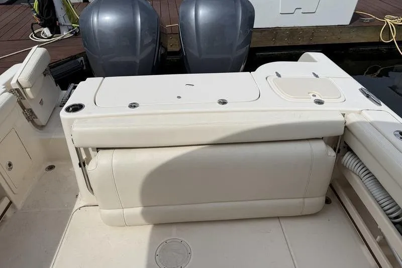 Slide: The Image of 2019 Grady-White Freedom 285 boat interior with dual engines and seating area. - 3