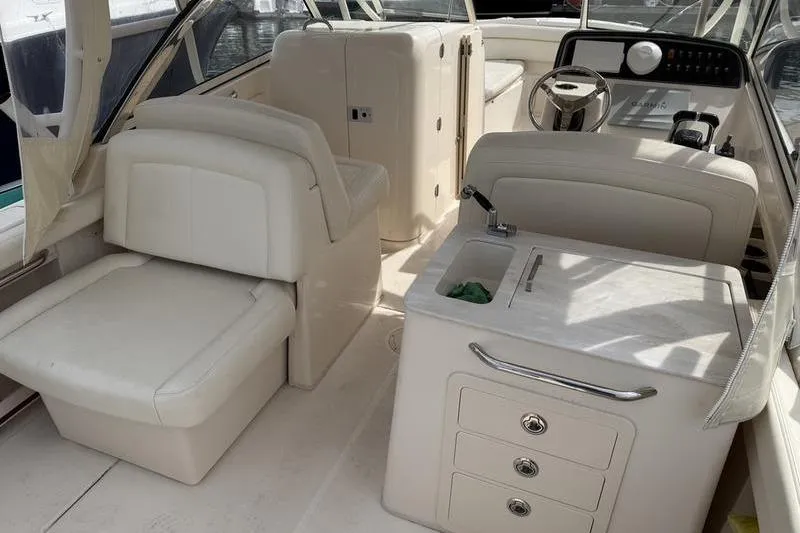 Slide: The Image of 2019 Grady-White Freedom 285 boat interior with seating, steering wheel, and sink. - 4