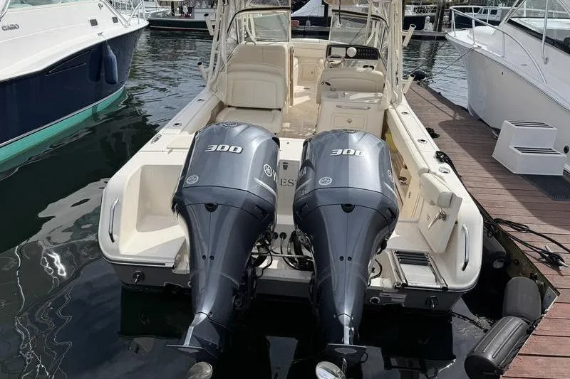 Slide: The Image of 2019 Grady-White Freedom 285 boat with twin 300 horsepower engines docked at marina. - 6