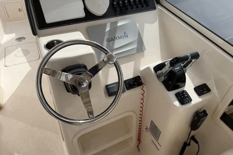 Slide: The Image of 2019 Grady-White Freedom 285 helm with Garmin navigation and steering wheel. - 8
