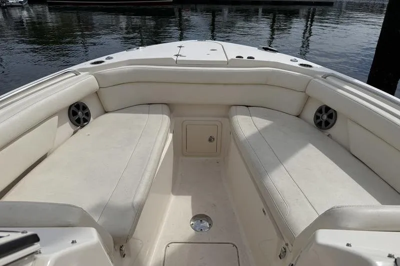 Slide: The Image of 2019 Grady-White Freedom 285 boat interior with cushioned seating and speakers. - 9