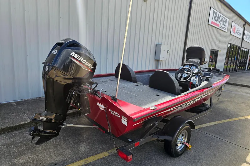Slide: The Image of 2021 Tracker Pro Team 175 TXW boat with Mercury engine, parked outside dealership. - 2