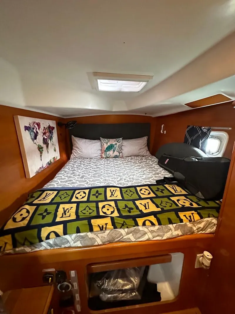 Slide: The Image of Cozy cabin interior of 2004 Lagoon 380 catamaran with stylish bedding and decor. - 11