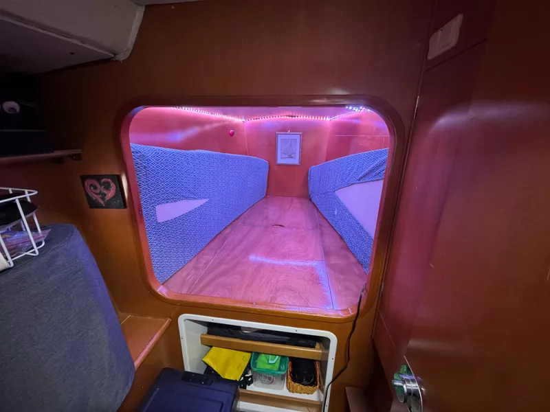 Slide: The Image of Cozy cabin interior of 2004 Lagoon 380 catamaran with ambient lighting and storage. - 13