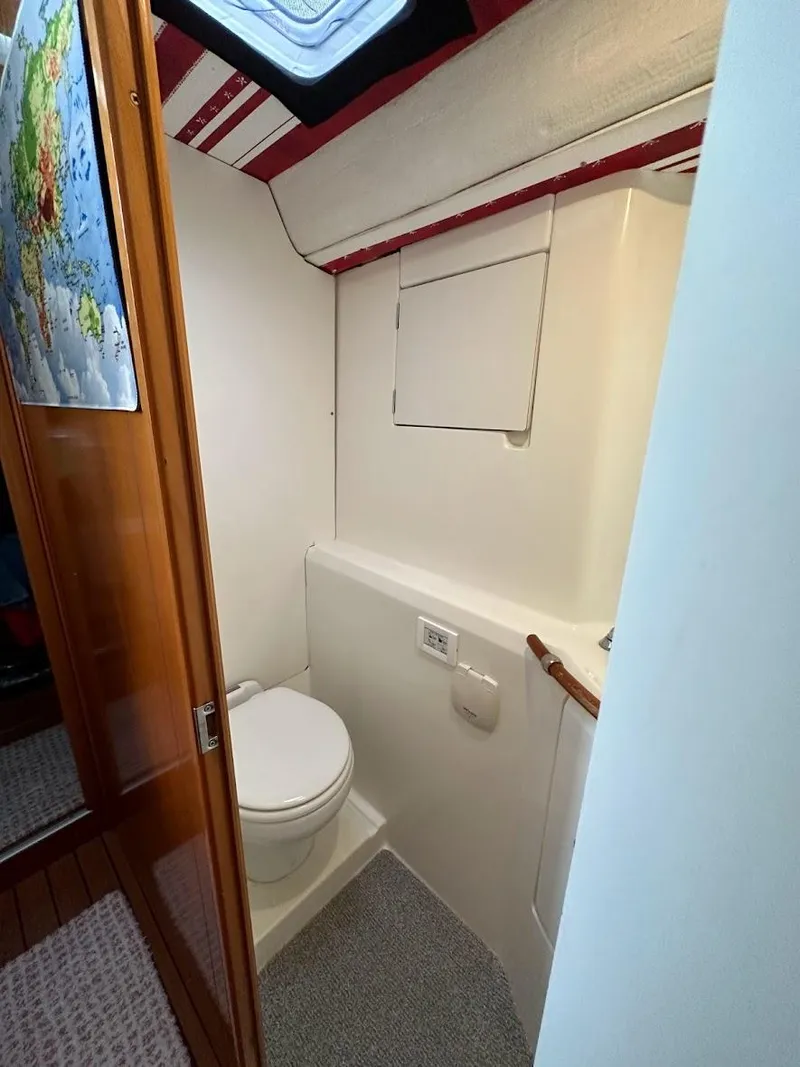 Slide: The Image of 2004 Lagoon 380 yacht bathroom with compact design and modern amenities. - 14