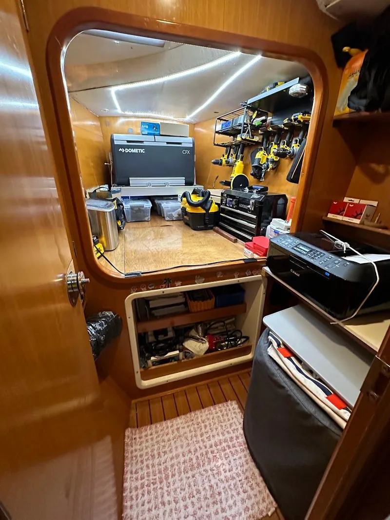 Slide: The Image of Interior of a 2004 Lagoon 380, featuring a well-organized workshop with tools and equipment. - 15