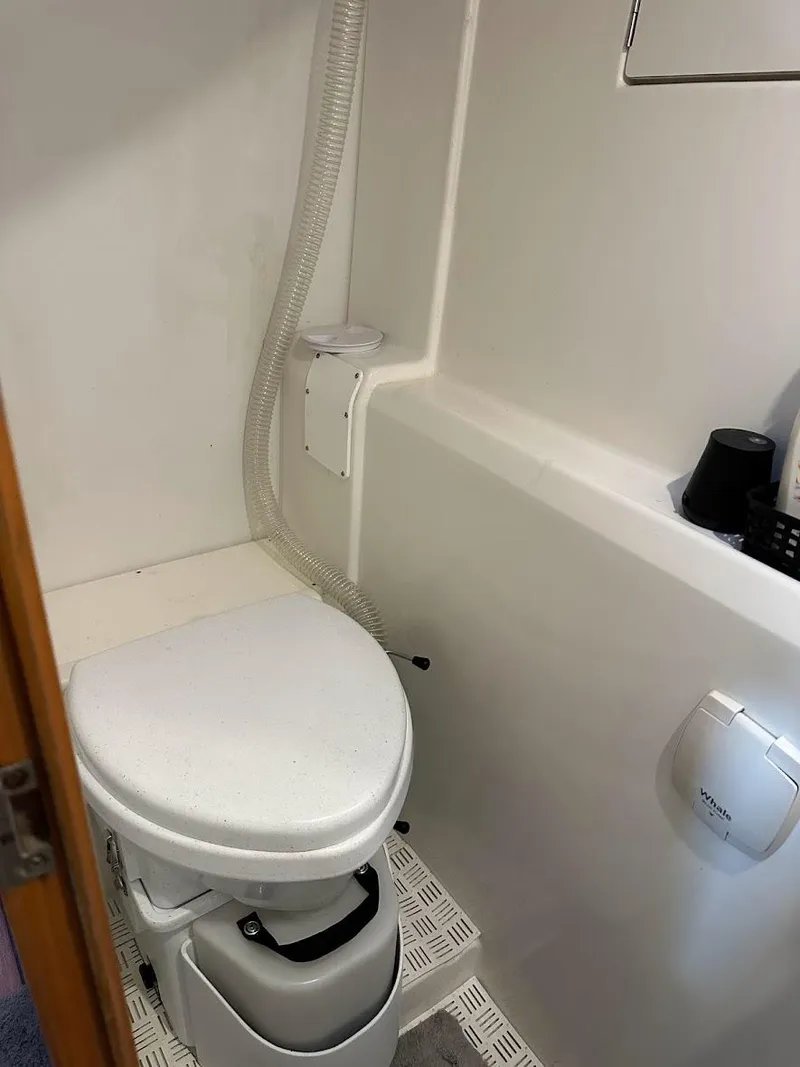 Slide: The Image of Compact marine toilet in a 2004 Lagoon 380 catamaran bathroom. - 20
