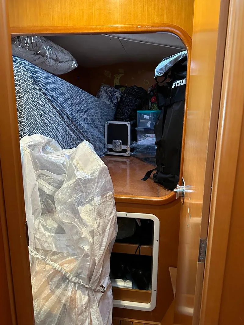 Slide: The Image of Interior cabin of a 2004 Lagoon 380 sailboat with storage and bedding. - 23