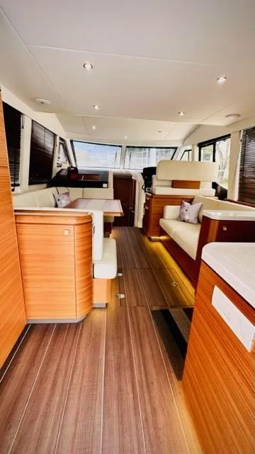 Slide: The Image of Luxurious interior of 2022 Greenline 48 Flybridge yacht with elegant wood finishes. - 10