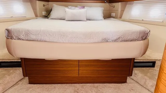 Slide: The Image of Luxurious bedroom interior of 2022 Greenline 48 Flybridge yacht with plush bedding. - 16