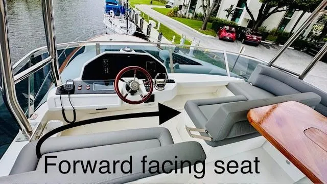 Slide: The Image of 2022 Greenline 48 Flybridge with Hardtop, featuring forward-facing seat and sleek helm design. - 27