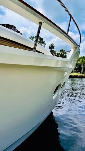 Slide: The Image of 2022 Greenline 48 Flybridge yacht with hardtop on calm water, showcasing sleek design. - 3