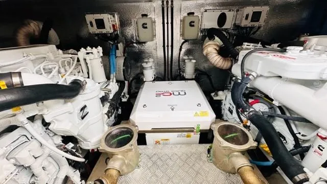 Slide: The Image of Engine room of 2022 Greenline 48 Flybridge yacht, showcasing mechanical components and systems. - 34