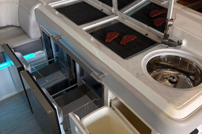 Slide: The Image of 2025 Sea Ray SLX 400 Outboard boat in a showroom, sleek design and modern features. - 1