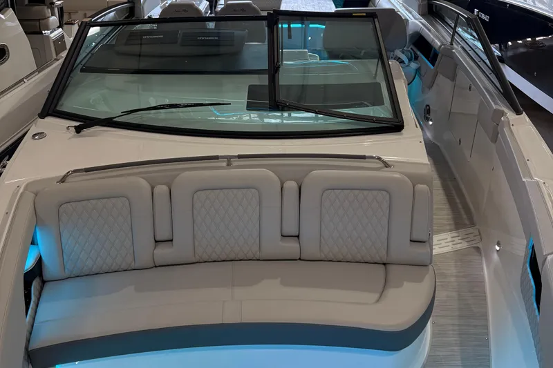 Slide: The Image of Dashboard of 2025 Searay 400 SLX boat with dual Simrad displays and steering wheel. - 11