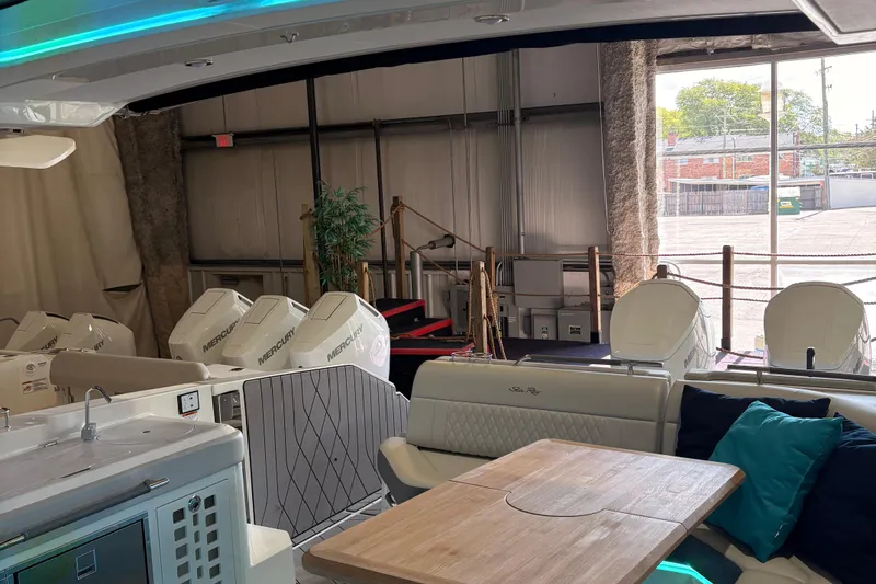 Slide: The Image of 2025 Searay 400 SLX boat interior with cushioned seating and integrated speakers. - 4