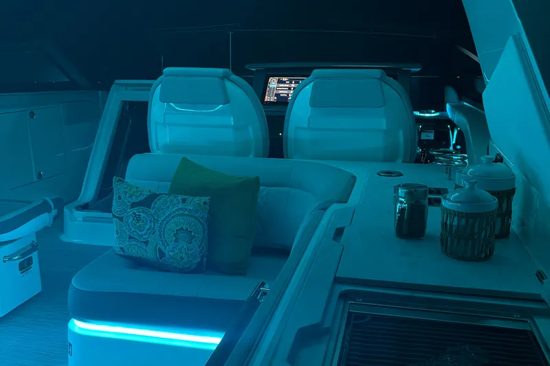 Slide: The Image of 2025 Searay 400 SLX boat interior with seating, table, and Mercury engines in a showroom. - 6