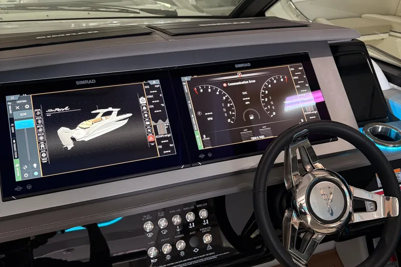 Slide: The Image of 2025 Searay 400 SLX yacht interior with ambient blue lighting and modern seating. - 9