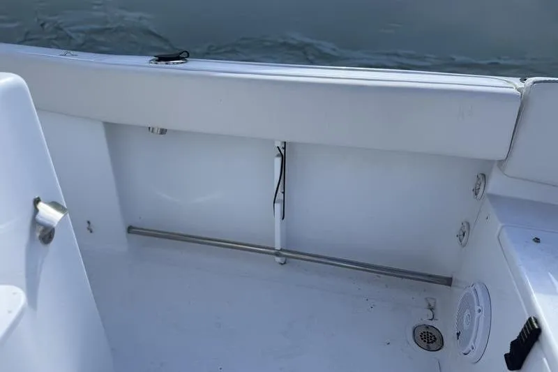 Slide: The Image of 2024 Sea Hunt Ultra 229 boat interior with white seating and clean deck. - 6