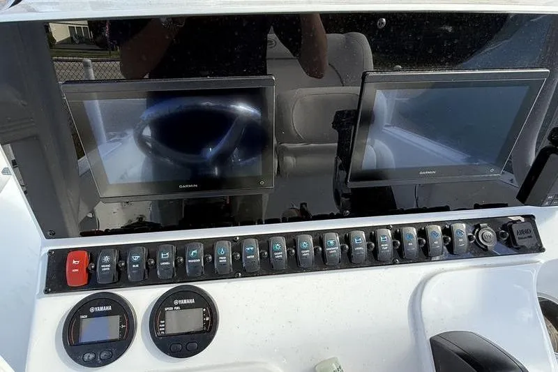Slide: The Image of 2024 Sea Hunt Ultra 229 dashboard with dual Garmin displays and Yamaha controls. - 8