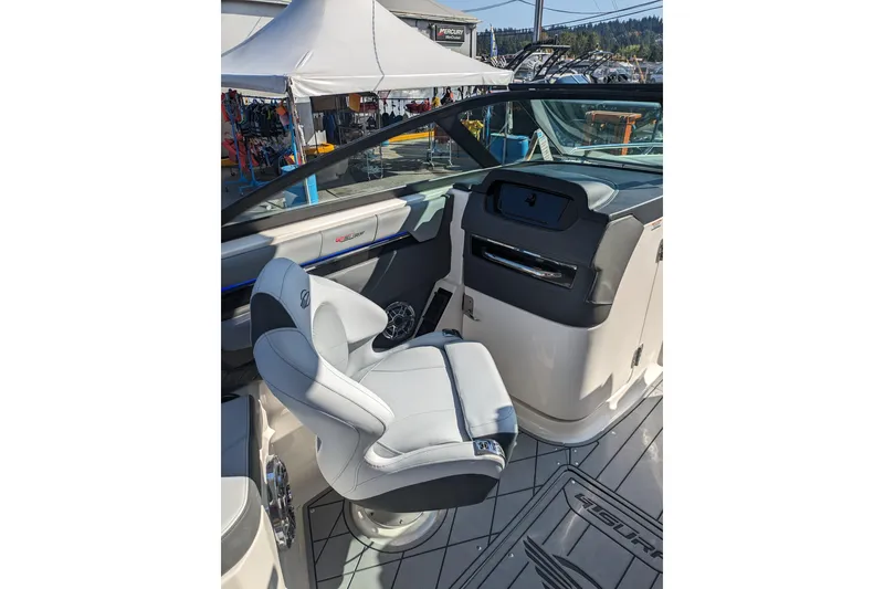 Slide: The Image of 2026 Chaparral 6 GTS boat interior with sleek white seating and modern dashboard. - 19