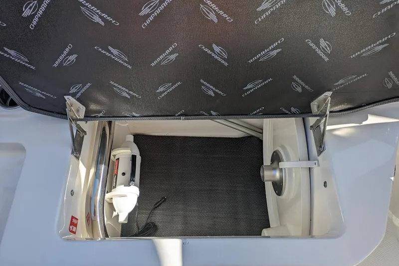 Slide: The Image of Open storage compartment in 2026 Chaparral 6 GTS boat, featuring branded interior lining. - 23