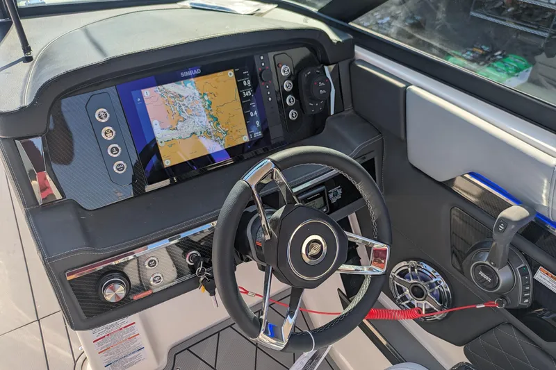 Slide: The Image of 2026 Chaparral 6 GTS boat dashboard with navigation display and modern steering wheel. - 5