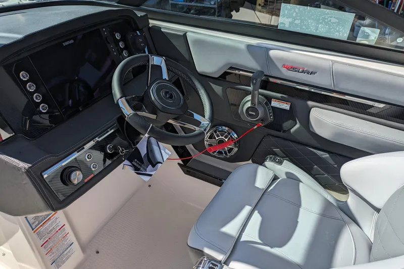 Slide: The Image of 2026 Chaparral 6 GTS boat interior with modern steering and control panel. - 6