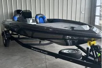 Slide: The Image of 2025 Ranger Z185 boat in a garage, sleek design, black exterior, on a trailer. - 3