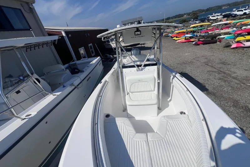 Slide: The Image of 2007 Sea Hunt Triton 240 boat docked, showcasing sleek design and spacious seating. - 10